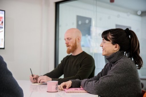 Two website designers sat at a table during a meeting